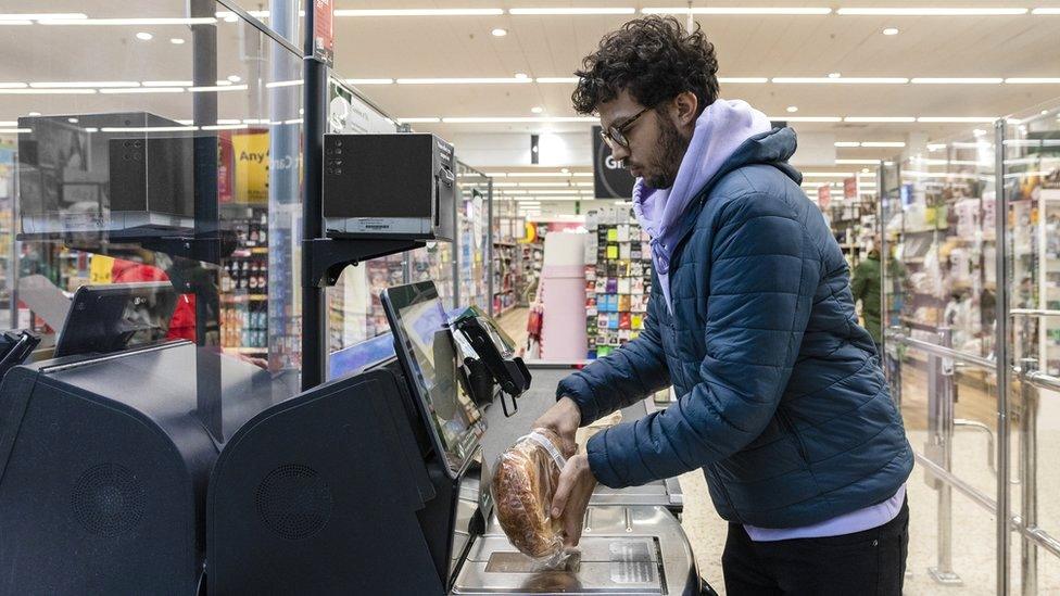 Stock image of a man using a self-scan