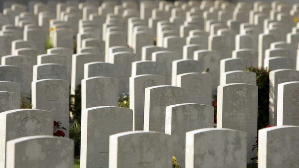 The grave stones of soldiers killed in the Battle of Somme line up at sunset at the Pozieres Memorial