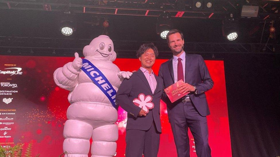 Chef Ryusuke Nakagawa from Toronto Japanese restaurant Aburi Hana posing with the Michelin man.