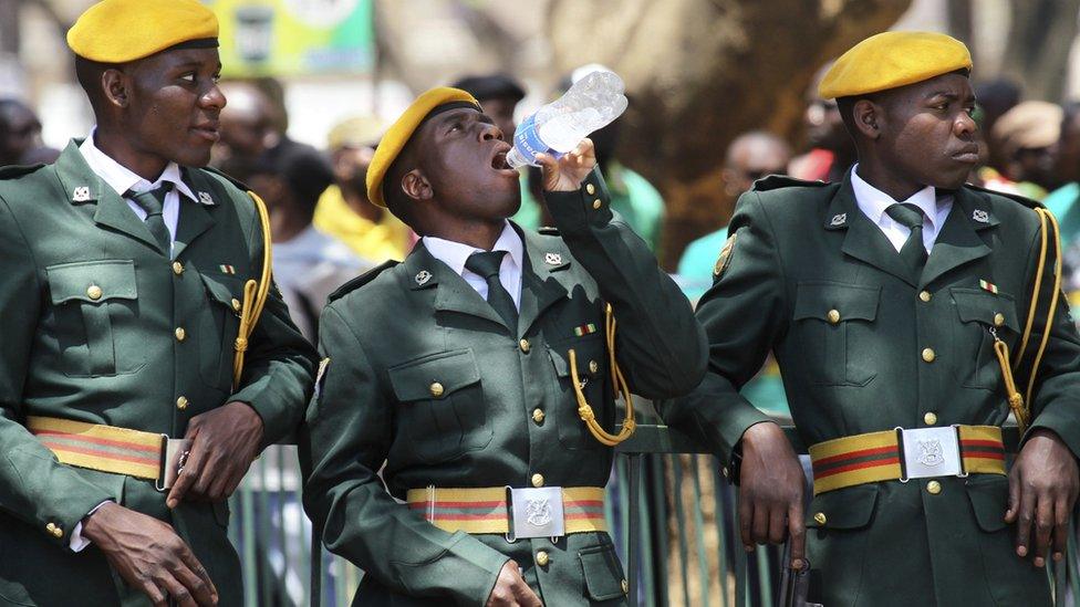Zimbabwean soldiers relax during the opening of the 4th session of the 8th Parliament of Zimbabwe in Harare, Thursday, Oct, 6, 2016. (AP Photo/Tsvangirayi Mukwazhi)