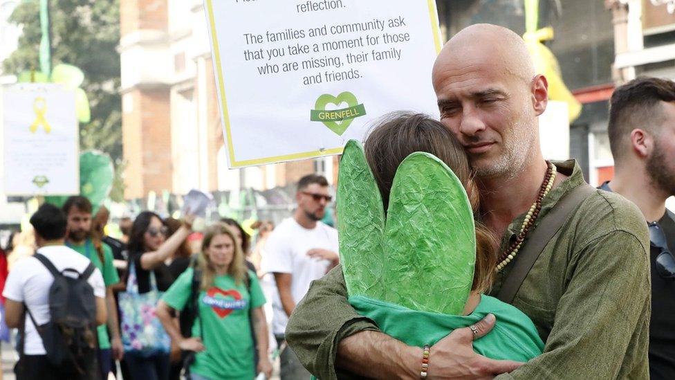 Carnival goers hug following the minute's silence