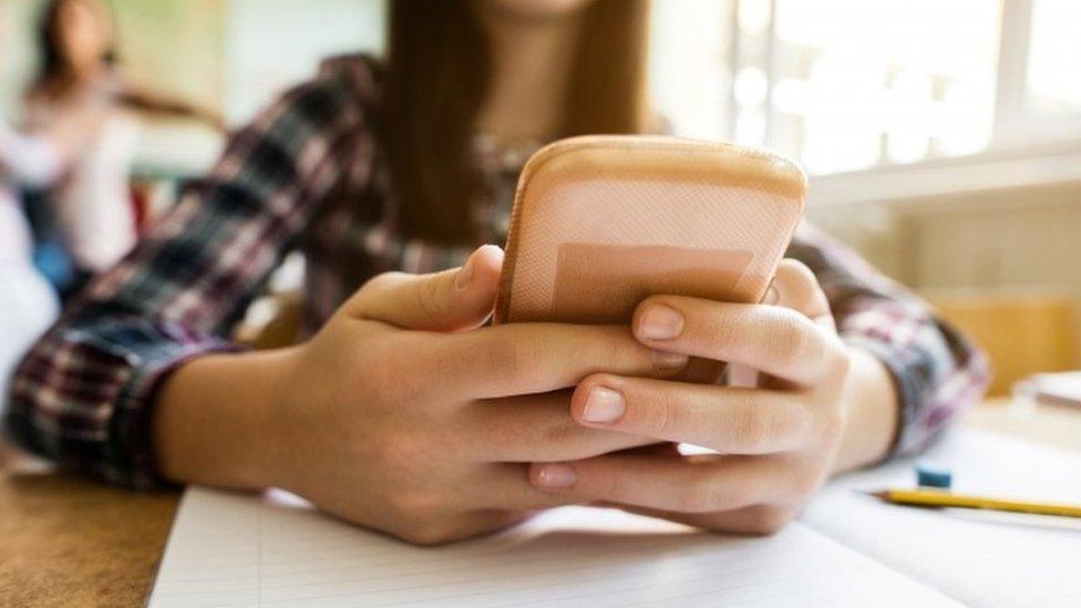 Teenage using mobile phone