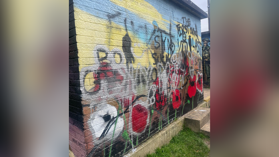 Spray paint over a war mural in Witham in Essex