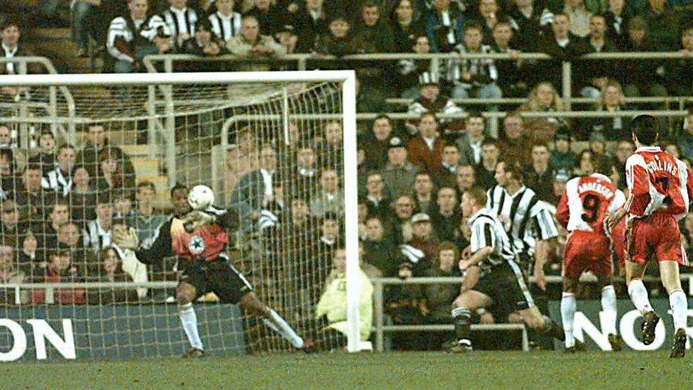 Monaco Striker Sonny Anderson Da Silva scores the winning goal against Newcastle United goalie Shaka Hislop 04 March, during a first-leg UEFA Cup quarter-final match at Saint James Park. Monaco won 1-0