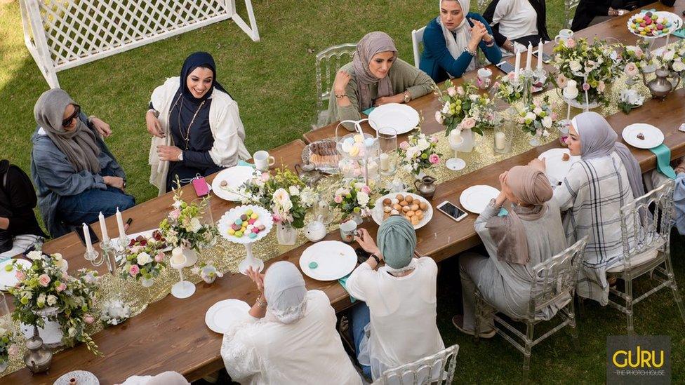 Followers of #MyChoice wearing hijab at a table