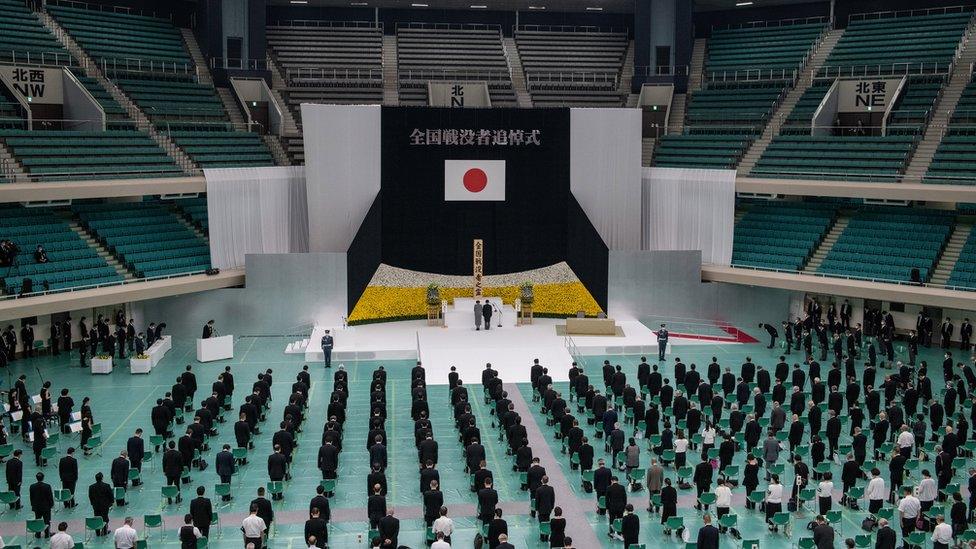 Image shows a memorial event in Tokyo