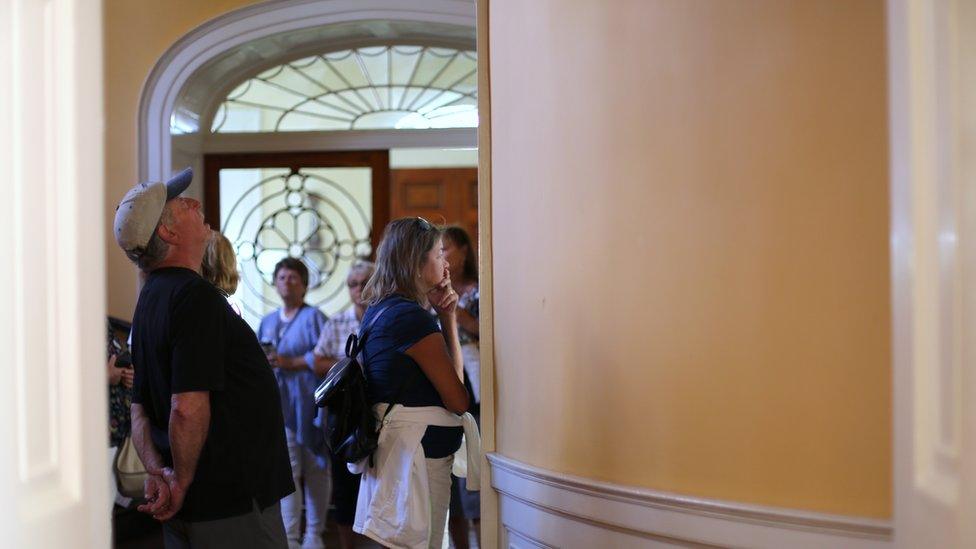 Tourists at the Nathaniel Russell House in Charleston