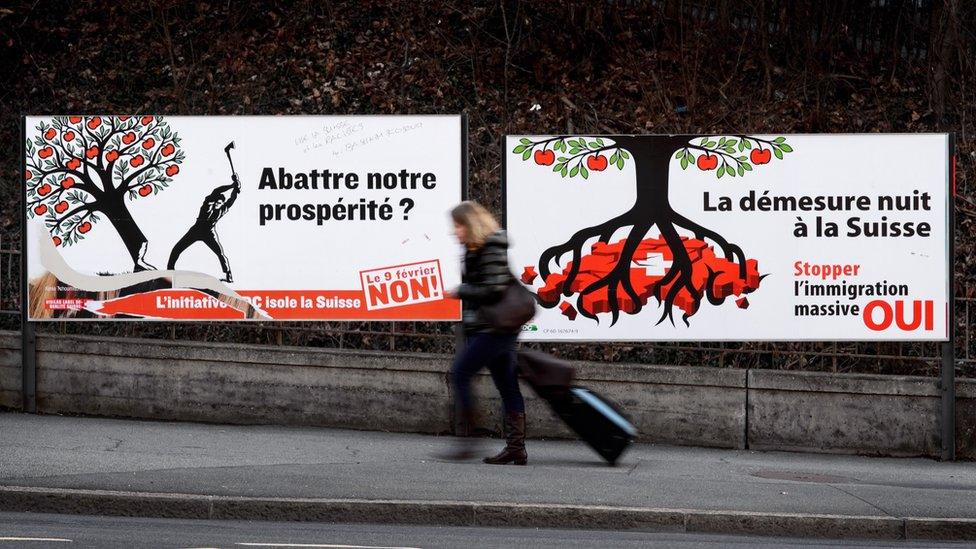 Two electoral posters against (L) and in favour (R) of a 'Stop Mass Immigration' referendum held on February 9, 2014