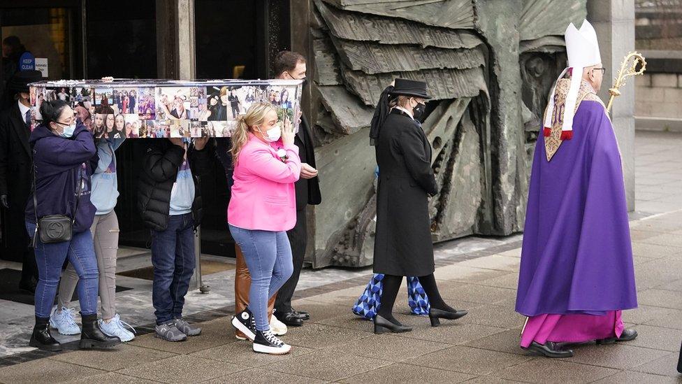 Archbishop leads out coffin after funeral