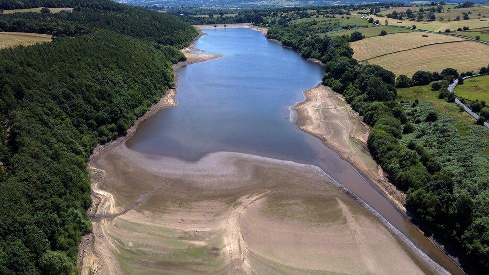 An aerial view of Lindley Wood reservoir in Otley, Britain in which the level of the water is visibly low