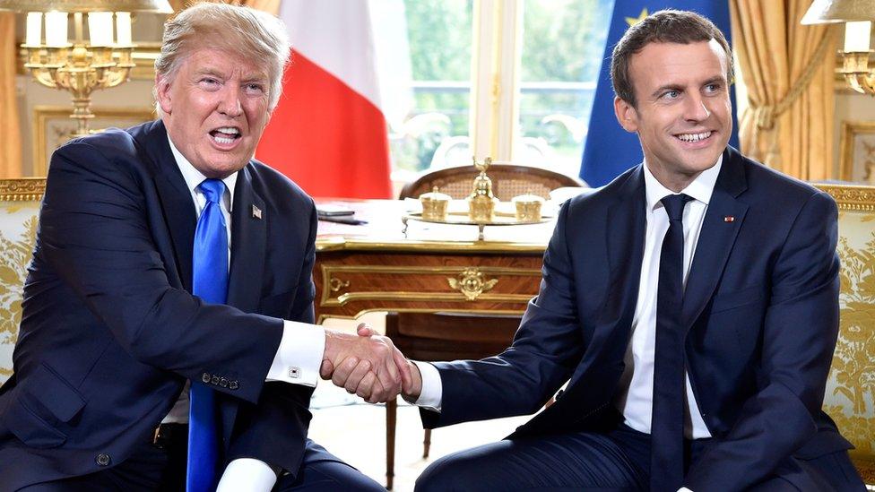 US President Donald Trump (left) shakes hands with French President Emmanuel Macron during their meeting at the Elysee Palace in Paris, France, 13 July 2017