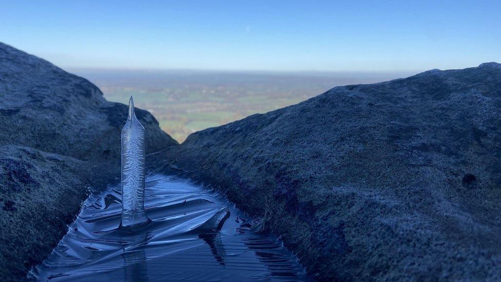 Ice spike sticking upwards from icy water