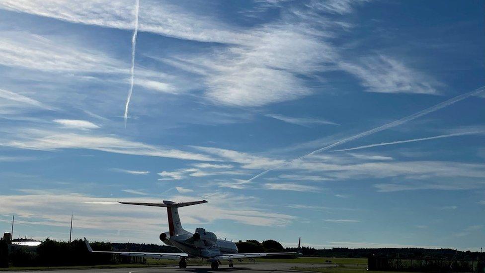 Contrails lining the sky