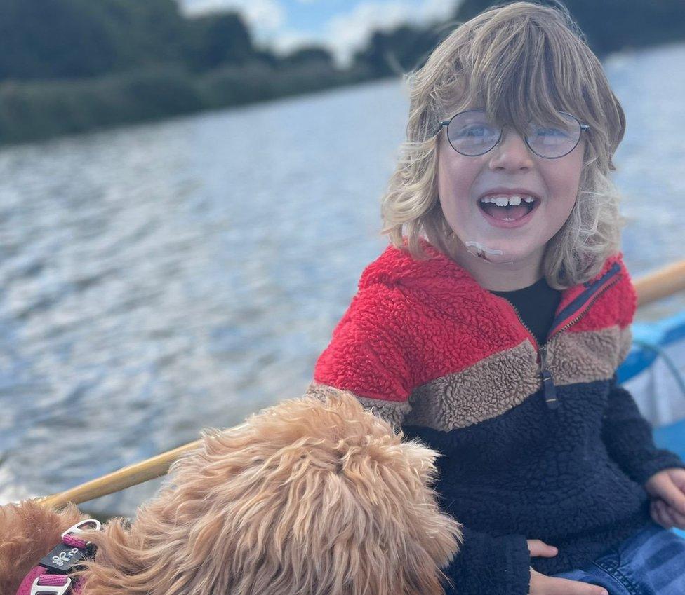 Rocco on a boat with the family dog