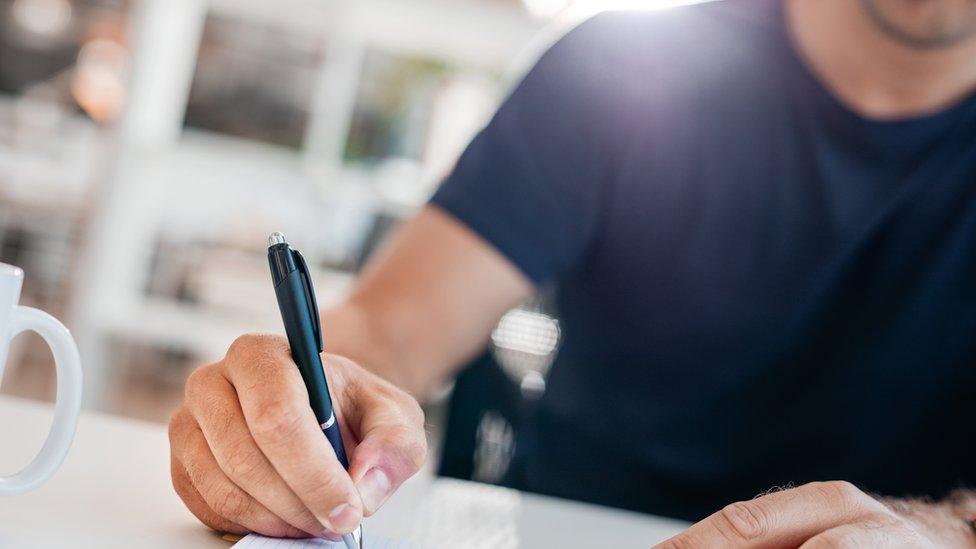 Man writing in journal