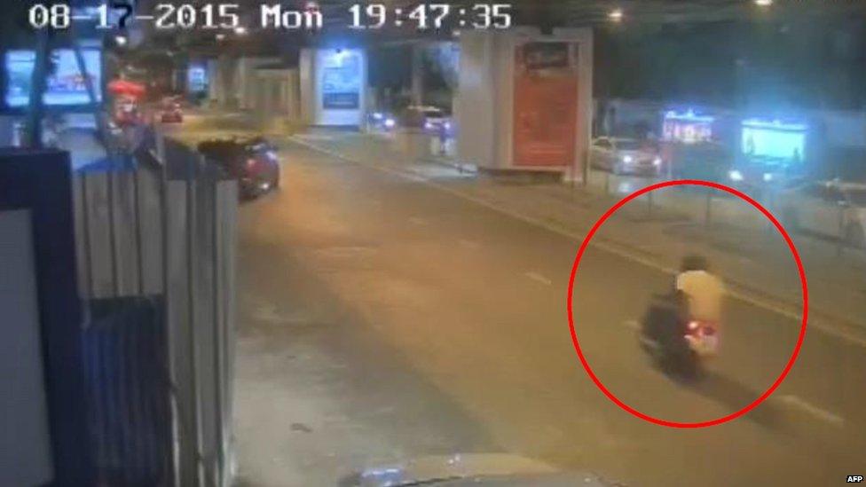 A CCTV image released by Thai police shows the main bombing suspect on the back of a motorbike, riding away from the shrine, just two minutes after a bomb was detonated