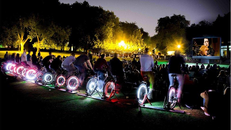 Row of cyclists at film screening