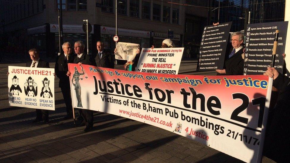 Birmingham pub bombing victims' families with banners