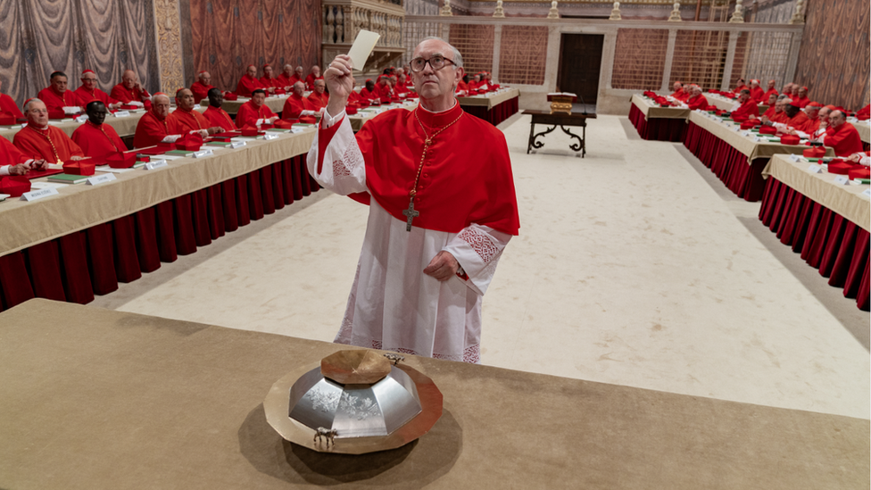 Jonathan Pryce as Cardinal Bergoglio casting his vote for the papacy