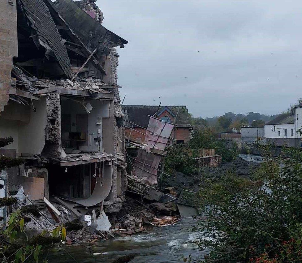 The damage to the rear of the building next to the river