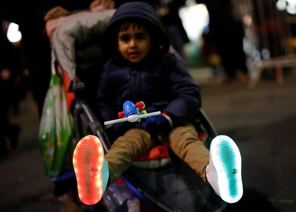 A boys shows his illuminated shoes during Diwali celebrations in Leicester