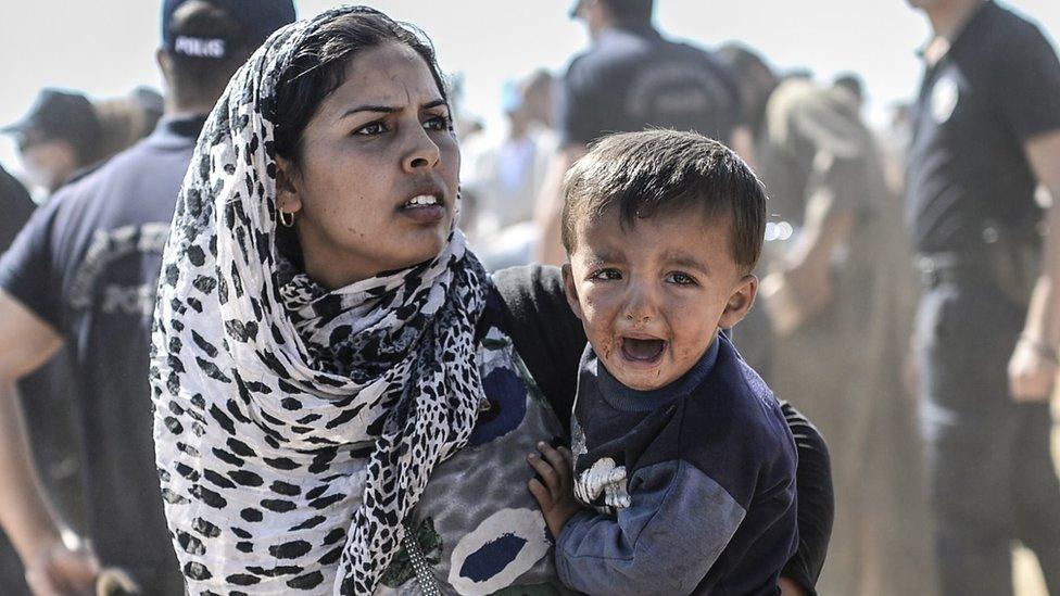 Woman holding a crying child