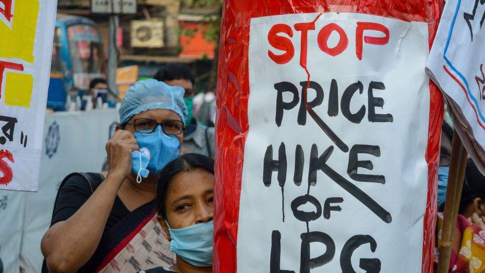 A replica of cooking gas cylinder was carried in the rally with slogans written over it as a sign of protest against rising price of cooking gas, in Kolkata, India, on December 4, 2020.