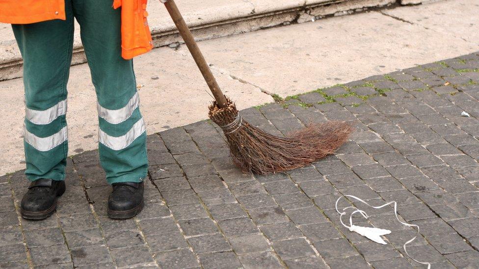 A street sweeper with a broom