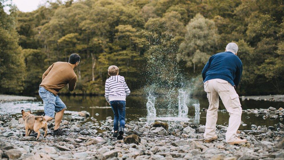 A family skimming stones