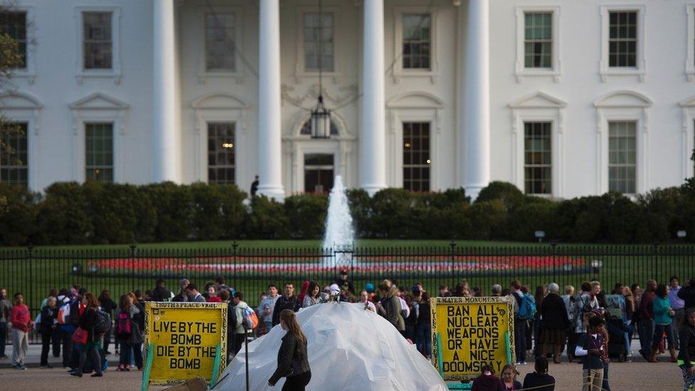 White House - with people holding signs in front