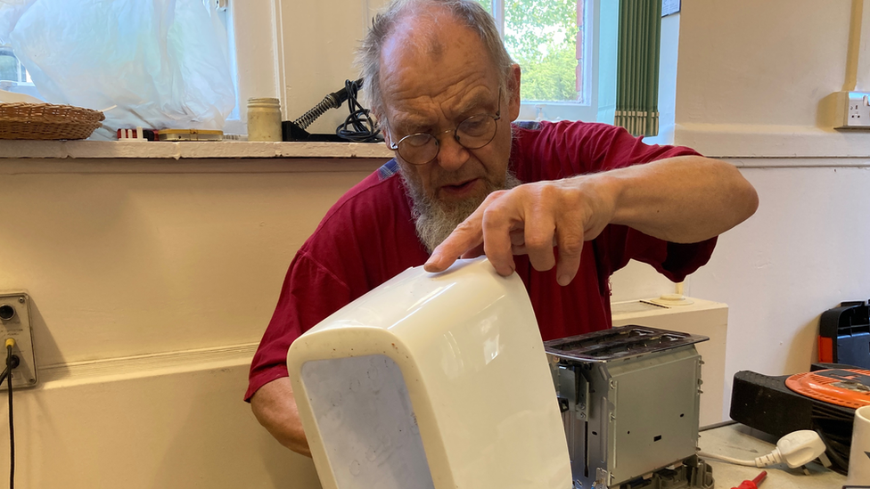 Man starting a repair on toaster