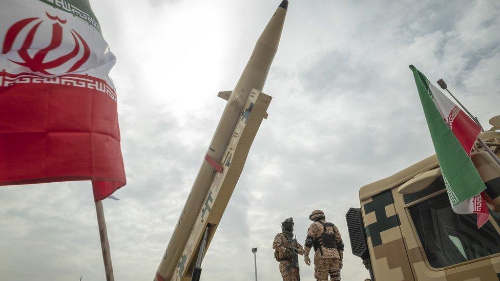 File photo showing members of Iran's Islamic Revolution Guard Corps (IRGC) standing next to a Kheibar Shekan (Castle Buster) ballistic missile during a rally in Tehran, Iran, on 29 April 2022