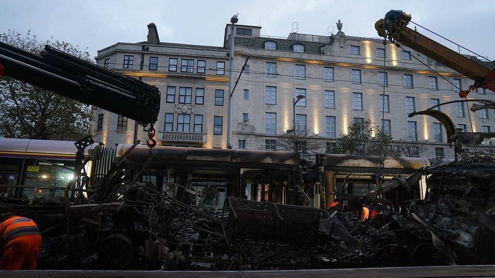 A burned out Luas is removed from O'Connell Street in Dublin, in the aftermath of violent scenes in the city centre on Thursday evening. The unrest came after an attack on Parnell Square East where five people were injured, including three young children