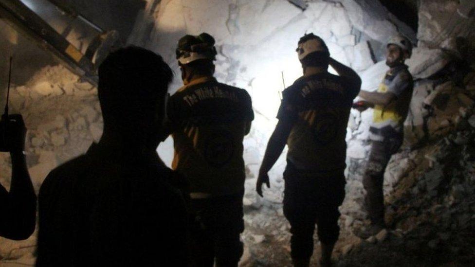 Syria Civil Defence (White Helmets) members search the rubble of a damaged building for victims, after a deadly airstrike, said to be in Maarat al-Numan, Idlib province