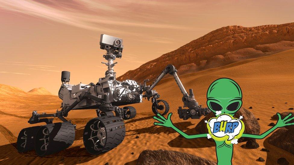 A cartoon alien burps in front of the Mars curiosity rover