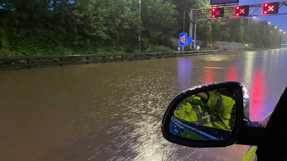 Flooded motorway seen from police car passenger window