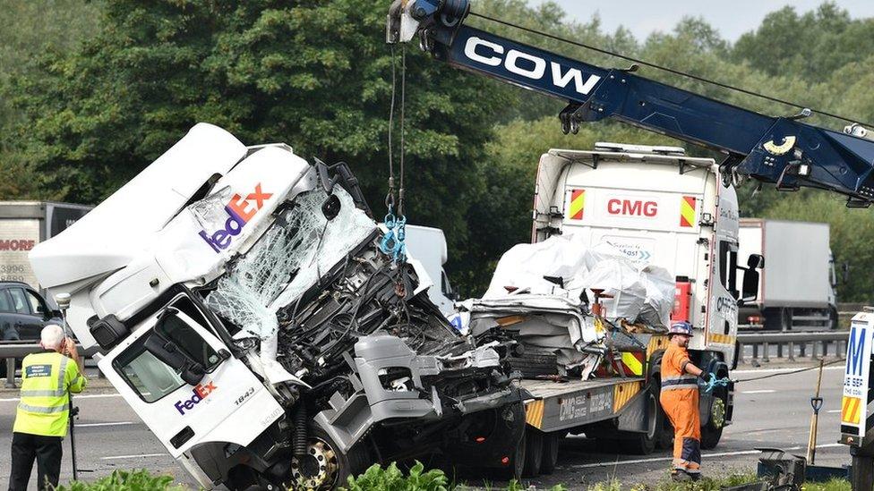 A lorry involved in the collision is towed away