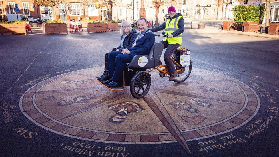 The mayor and his wife taking a ride in the rickshaw in Thetford