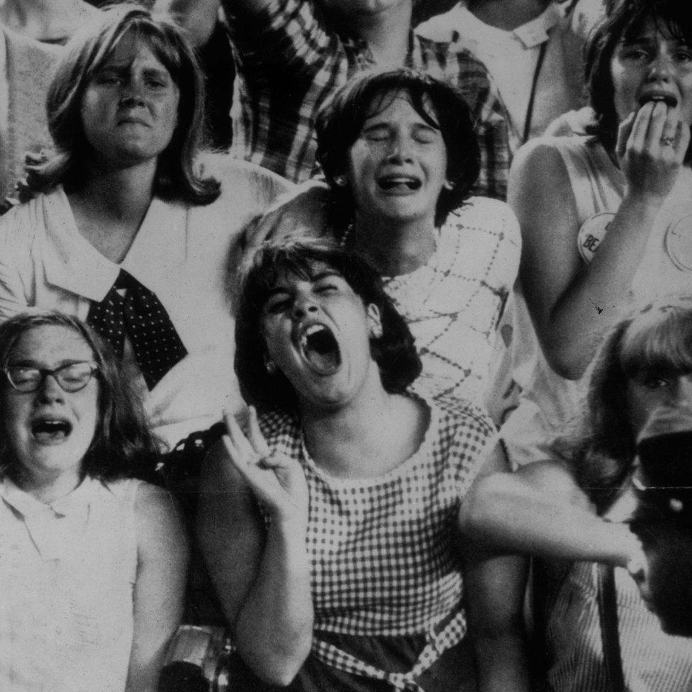 A group of girls reacting in different ways to The Beatles' performances