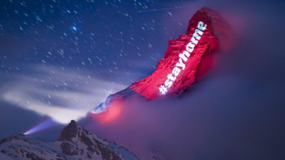 The Matterhorn mountain is illuminated to send messages of hope and solidarity with coronavirus patients