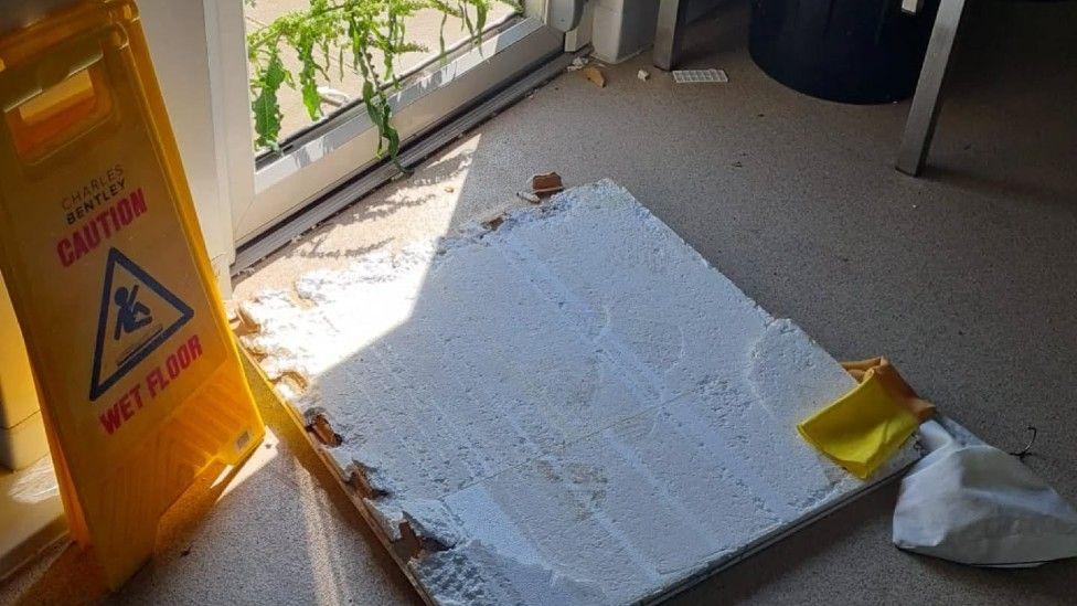 Damage near the door of a fish and chip shop.