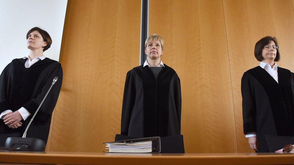 Three judges in the courtroom