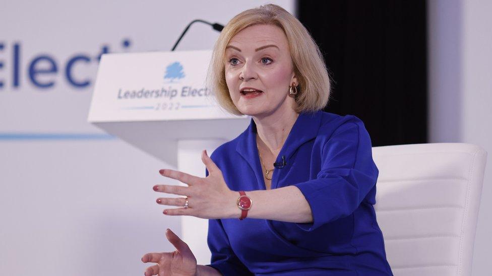 Prime ministerial hopeful Liz Truss speaking on stage at an event