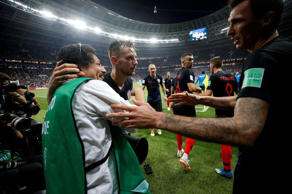 Croatia's Ivan Rakitic and Mario Mandzukic celebrate with an AFP photographer Yuri Cortez after their second goal