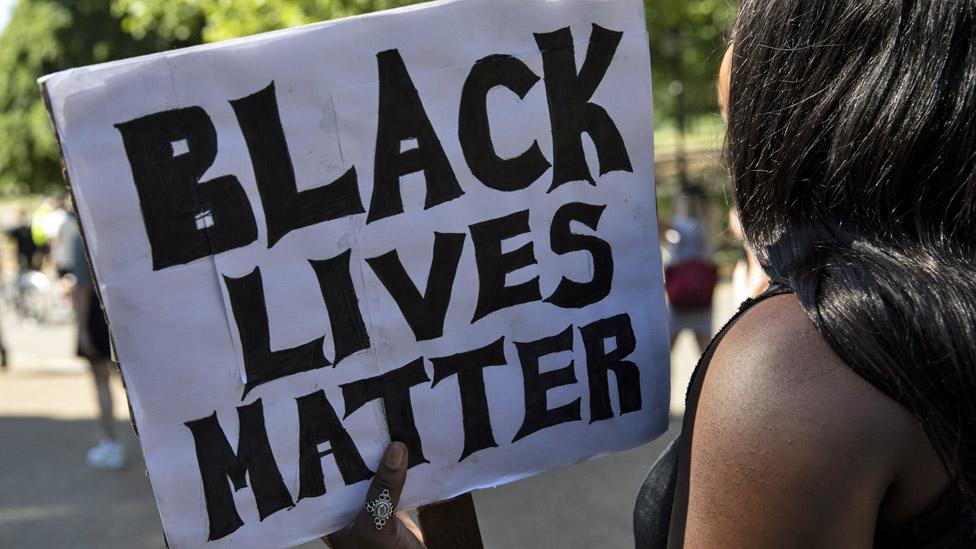 Protester holding a placard saying "Black lives matter"