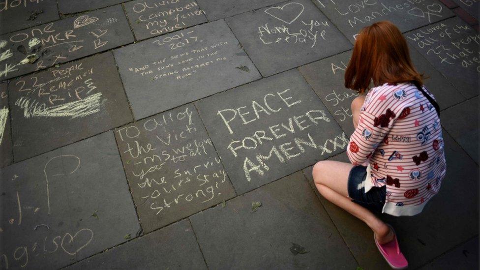 Woman writing message in St Ann's Square