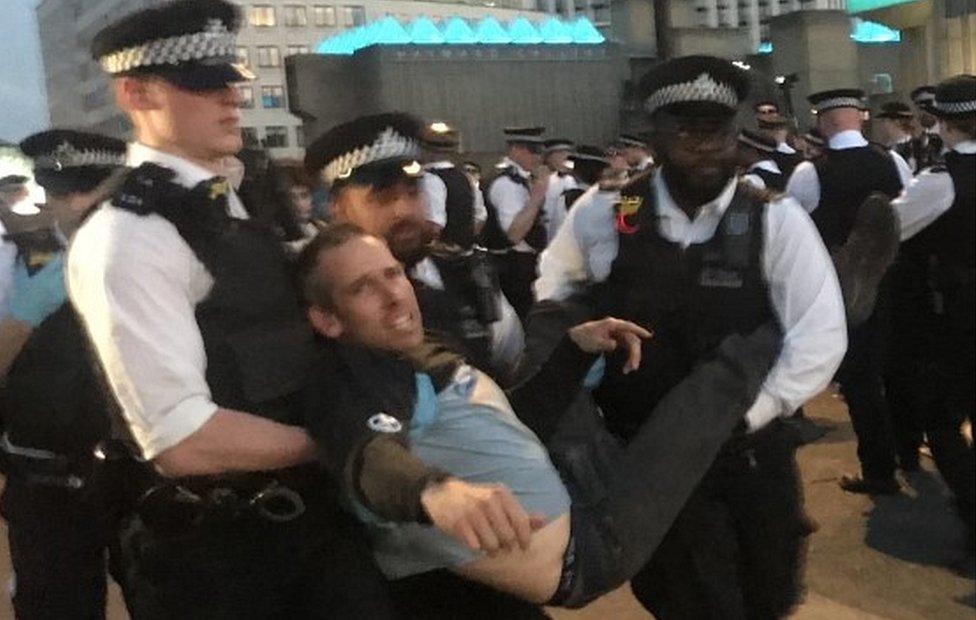 Etienne Stott being arrested by police