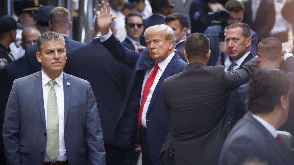 Trump waves to supporters