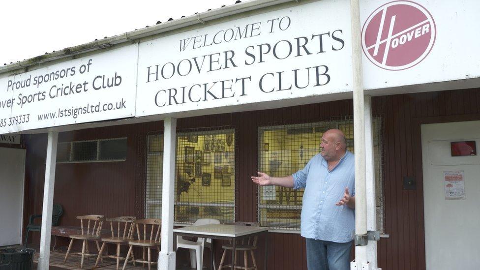 Steve Speirs under a sign saying 'Hoover Sports Cricket Club'