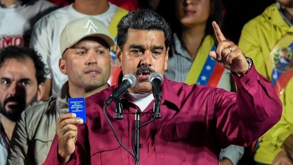 Venezuelan President Nicolas Maduro holds the political constitution after the National Electoral Council (CNE) announced the results of the voting on presidential election, on May 20, 2018, in Caracas, Venezuela.